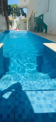 a blue tile swimming pool with a blue tile floor at Roses House Ladies or families only in Luxor