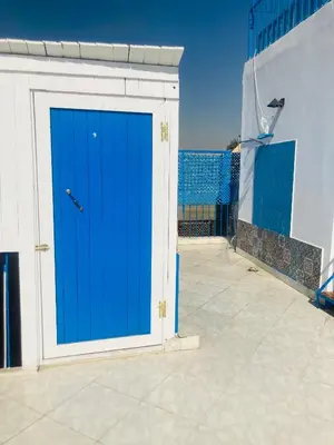 a blue door on the side of a building at Roses House Ladies or families only in Luxor