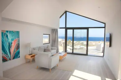 a living room with a couch and a large window at Modern Soma Bay 2BR Villa w sea views, beach & pool access in Hurghada
