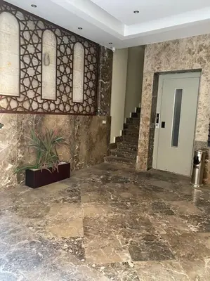a lobby with a staircase and a door with a plant at One bedroom with sea view in the centre in Hurghada