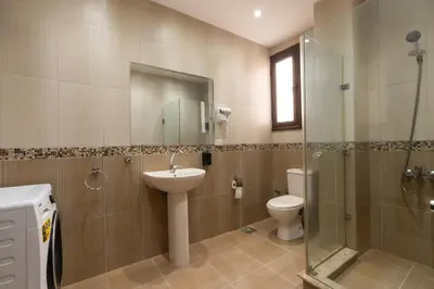 a bathroom with a toilet and a sink and a shower at One bedroom with sea view in the centre in Hurghada