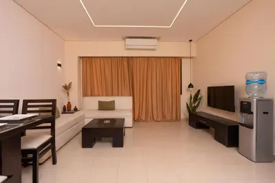 a living room with a couch and a television at One bedroom with sea view in the centre in Hurghada