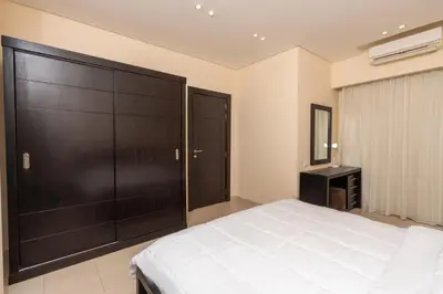a bedroom with a large bed and a large closet at One bedroom with sea view in the centre in Hurghada