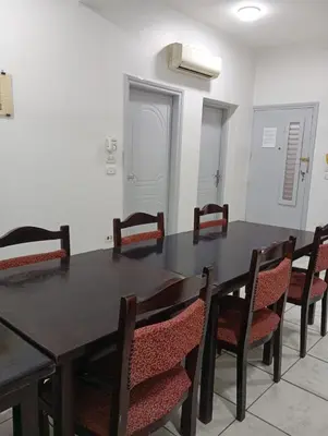 a dining room with a black table and chairs at Abeer Guest House in Luxor