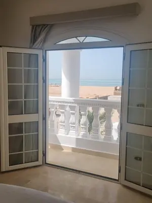 a sliding glass door with a view of a balcony at White House Hurghada in Hurghada