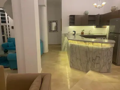 a kitchen with a island in the middle of a room at White House Hurghada in Hurghada