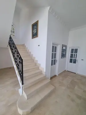 a staircase in a room with white walls and floors at White House Hurghada in Hurghada