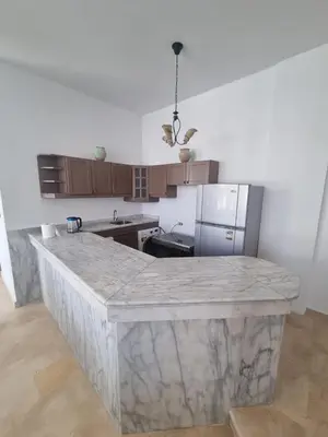 a kitchen with a large marble island in the middle at White House Hurghada in Hurghada