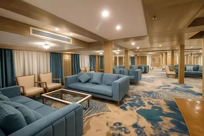 a large waiting room with blue couches and chairs at Five Star Deluxe River Kruz from Aswan to Luxor 3 Nights in Aswan