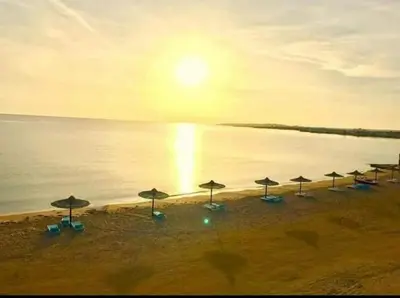 a group of umbrellas on a beach with the ocean at Cecelia Resort Hurghada in Hurghada