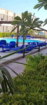 a group of blue tables and chairs at a pool at Cecelia Resort Hurghada in Hurghada