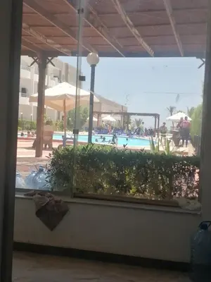 a view of a swimming pool through a window at Cecelia Resort Hurghada in Hurghada