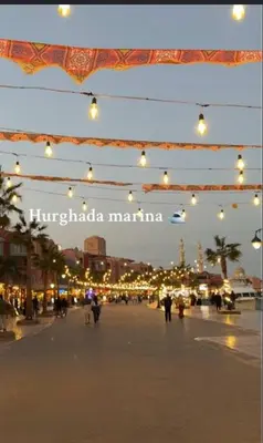 a group of lights hanging over a street at night at Sheraton Plaza Marina Blast 2 bedroom 2 bathroom in Hurghada