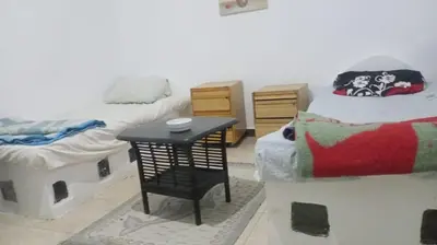a room with two twin beds and a small table at Sheraton Plaza Marina Blast 2 bedroom 2 bathroom in Hurghada