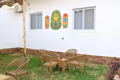 a table and chairs in front of a building at Diamond Guest House in Luxor