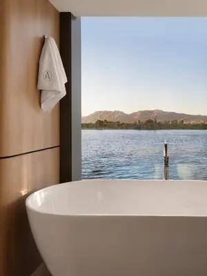 a bath tub in a bathroom with a view of the water at STORIA THE DAHABEYA - Mondays from Luxor for 4 & 7 Nights, and Fridays from Aswan for 3 & 7 Nights - Available for Private Bookings in Luxor