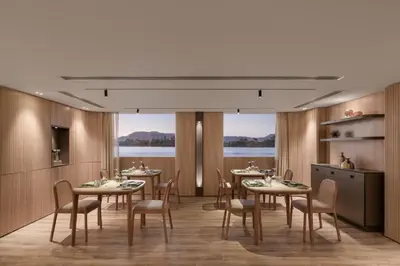 a dining room with tables and chairs and a large window at STORIA THE DAHABEYA - Mondays from Luxor for 4 & 7 Nights, and Fridays from Aswan for 3 & 7 Nights - Available for Private Bookings in Luxor