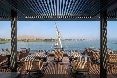 a deck of a boat with tables and chairs at STORIA THE DAHABEYA - Mondays from Luxor for 4 & 7 Nights, and Fridays from Aswan for 3 & 7 Nights - Available for Private Bookings in Luxor