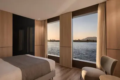 a bedroom with a bed and a view of the water at STORIA THE DAHABEYA - Mondays from Luxor for 4 & 7 Nights, and Fridays from Aswan for 3 & 7 Nights - Available for Private Bookings in Luxor