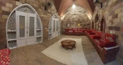a living room with a couch and red chairs at Shahhat Flat in Luxor