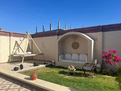 a patio with a white couch on the side of a building at West Bank luxury villa in Luxor