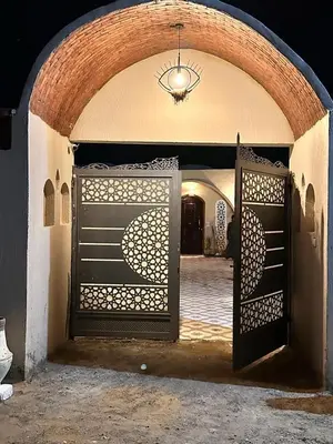 an entrance to a building with an open gate at West Bank luxury villa in Luxor