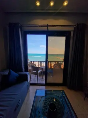 a living room with a couch and a view of the ocean at Hurghada Concierge at Turtles Beach Resort in Hurghada