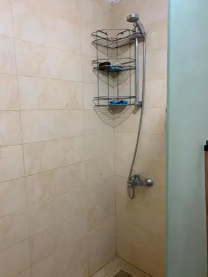a bathroom with a shower with a shower head at Hurghada Concierge at Turtles Beach Resort in Hurghada