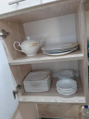 a cabinet filled with plates and bowls and dishes at Casablanca beach family suites in Hurghada