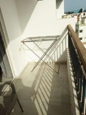 a stair case with a glass railing and a chair at Al makramia Compound in Hurghada