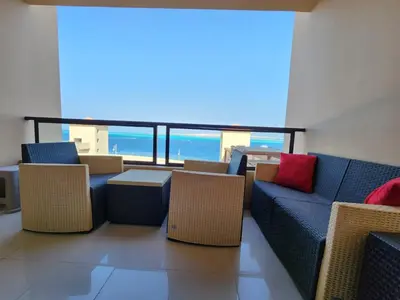 a room with couches and chairs and a view of the ocean at apartment in hurghada307 in Hurghada