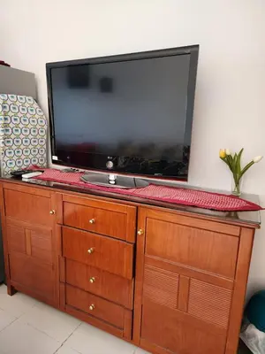 a flat screen tv sitting on top of a wooden dresser at apartment in hurghada307 in Hurghada