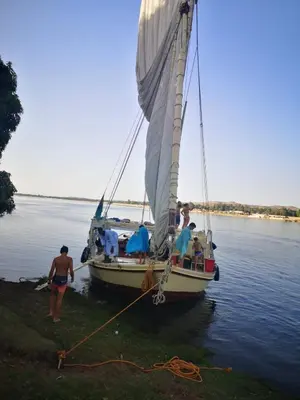 a group of people on a sail boat in the water at Aswan Felucca sailing boat and Hotel in Aswan