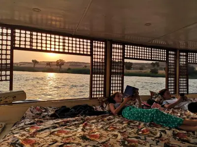 a group of children laying on a bed in a boat at Aswan Felucca sailing boat and Hotel in Aswan