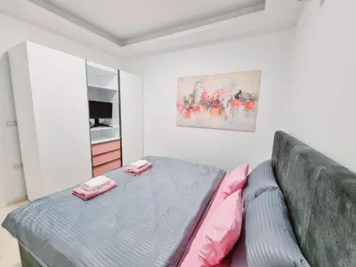 a bedroom with a bed with pink pillows on it at Selena Bay Hurghada - Pink Apartment in Hurghada