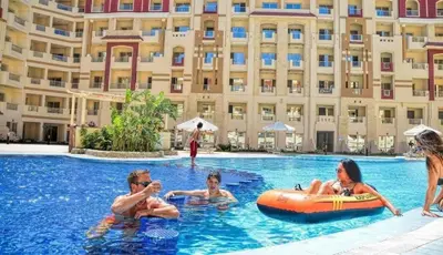 a group of people in a swimming pool at a hotel at Floranza khamsin hurgada منتجع فلورنزا الغردقه in Hurghada