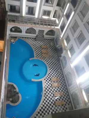 a swimming pool in the middle of a building at شقة 327صغيرة جميلة هادئة وسط المدينة in Hurghada