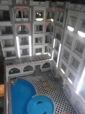 an overhead view of a building with a swimming pool at شقة 327صغيرة جميلة هادئة وسط المدينة in Hurghada