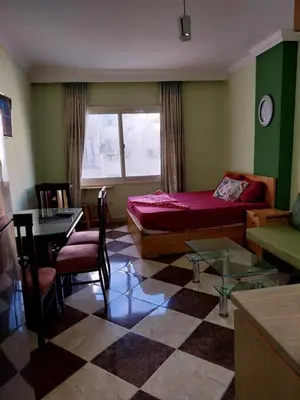 a bedroom with a bed and a table and chairs at شقة 327صغيرة جميلة هادئة وسط المدينة in Hurghada