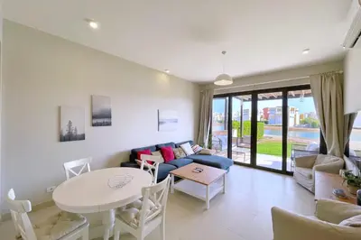 a living room with a couch and a table at Homey 3 BDR Townhouse Tawila El Gouna in Hurghada