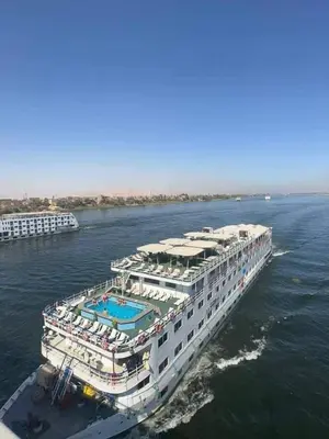 a cruise ship in the water with a pool at Royal Cruise Aswan to Luxor 3 Night And visit the Nubian village in Luxor