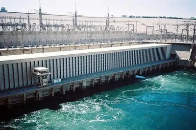 a bridge over a river with blue water at Royal Cruise Aswan to Luxor 3 Night And visit the Nubian village in Luxor