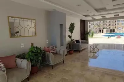 a living room with couches and a swimming pool at Perfect for couples, Sunny & SeaView & Free Wi-fi in Hurghada