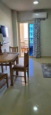 a dining room with a table and chairs and a window at Perfect for couples, Sunny & SeaView & Free Wi-fi in Hurghada