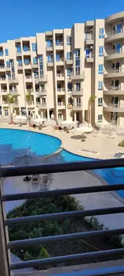 a view of a swimming pool in front of a building at Perfect for couples, Sunny & SeaView & Free Wi-fi in Hurghada