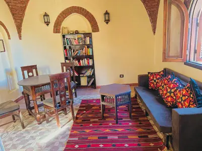 a living room with a couch and a table at Ramses Apartment in Luxor
