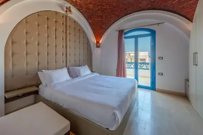 a bedroom with a large bed and a large window at Spacious villa with private pool in Hurghada