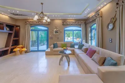 a large living room with a couch and a table at Spacious villa with private pool in Hurghada