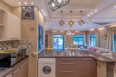 a kitchen with a washer and dryer in a room at Spacious villa with private pool in Hurghada