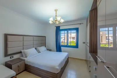 a bedroom with a large bed and a window at Spacious villa with private pool in Hurghada